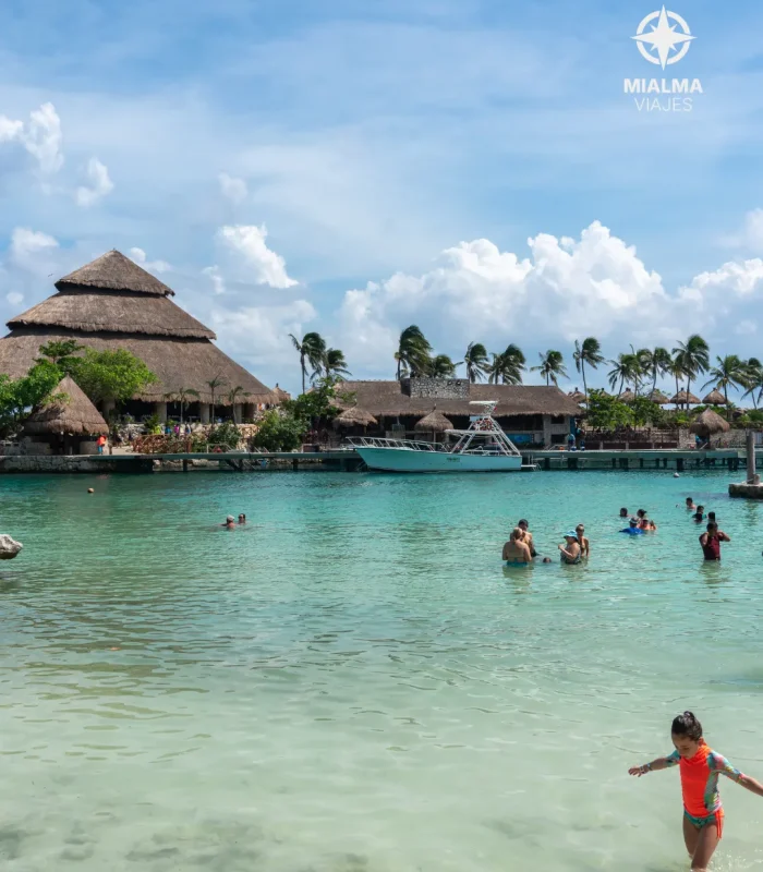 Imagen de niños bañándose en mar caribe. Logo de Mialma viajes agencia de viajes en familia en esquina superior derecha.